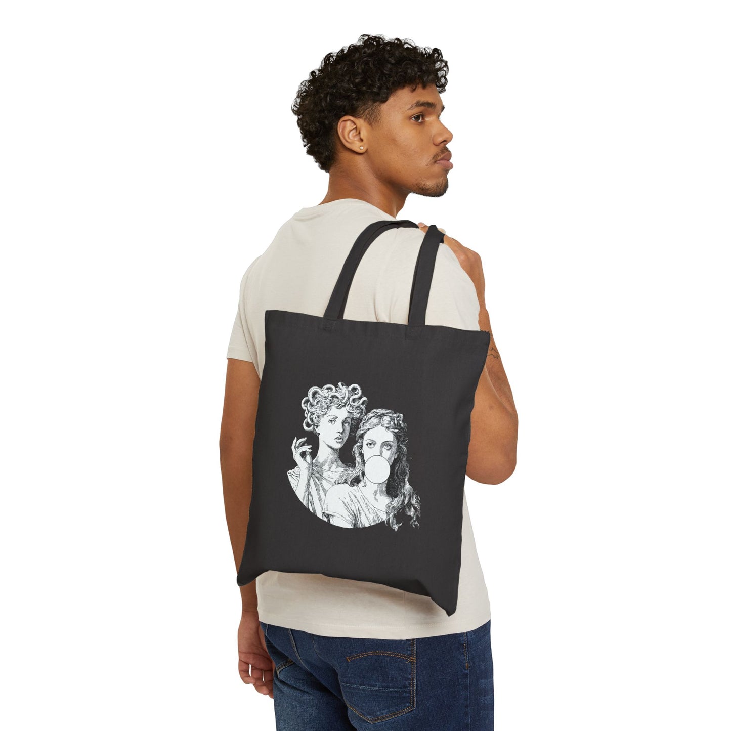 Man carrying a black tote bag with a graphic design on a white background
