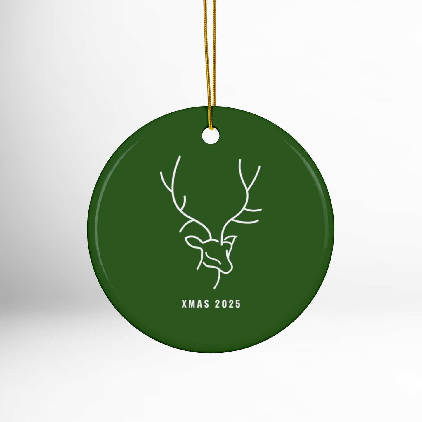 Green Christmas ornament with deer design and 'XMAS 2025' text on a white background