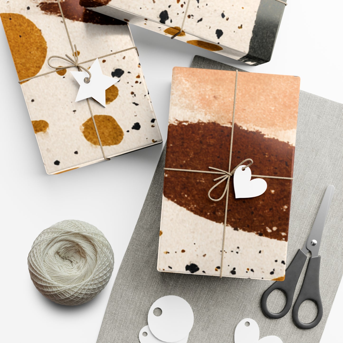Gift boxes with decorative paper, ribbons, and tags on a white surface.