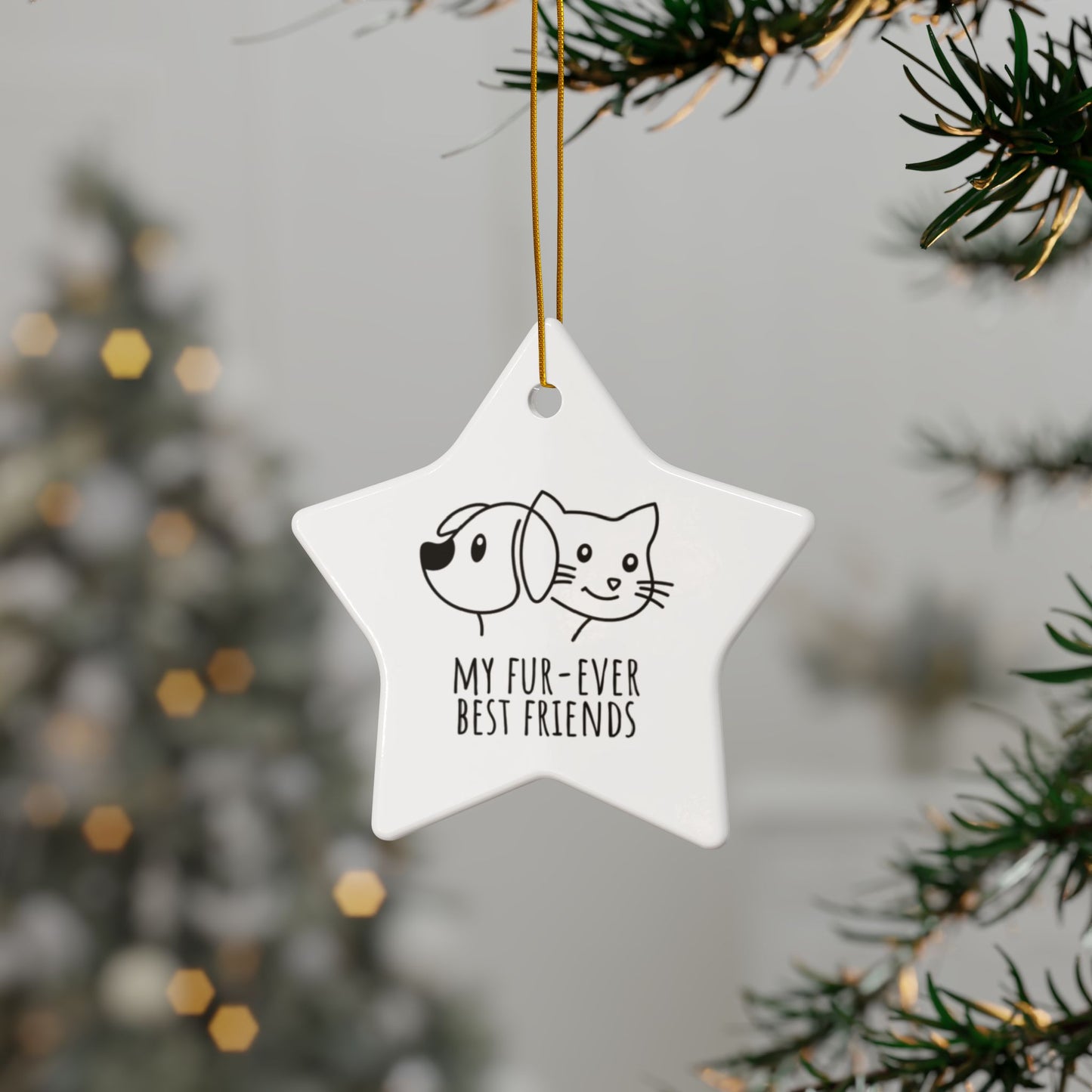 Star-shaped ornament with dog and cat illustration and text 'My fur-ever best friends' hanging on a tree.