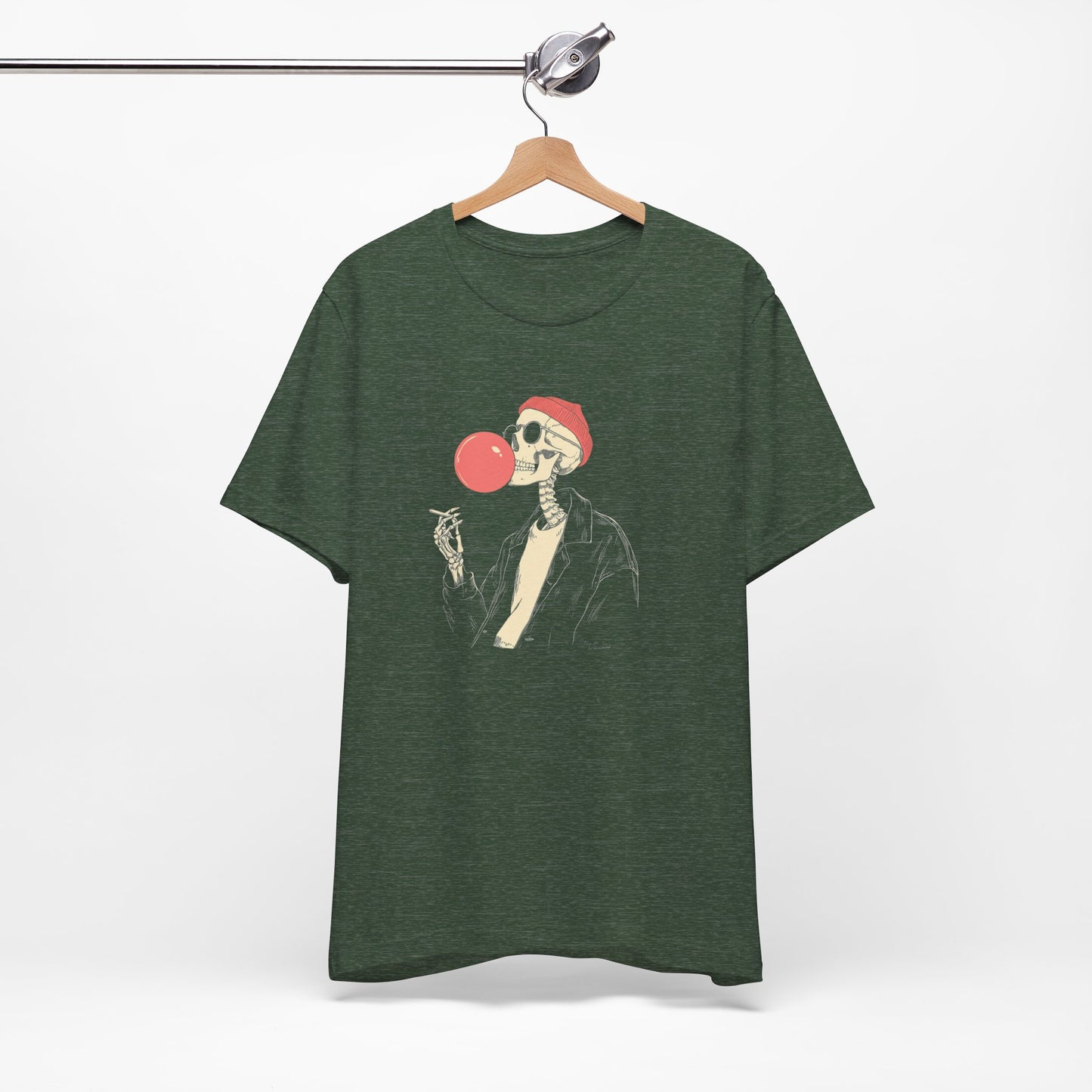 Green t-shirt with a skeleton blowing a red bubble gum bubble design on a hanger against a white background.