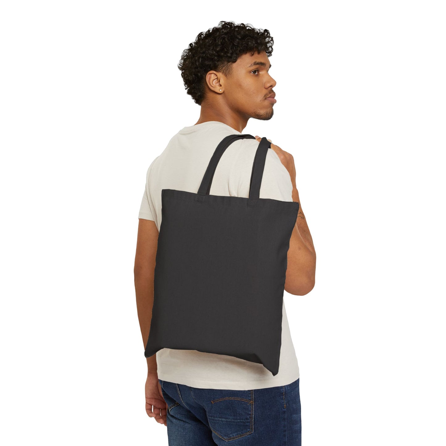 Man carrying a black tote bag on a white background