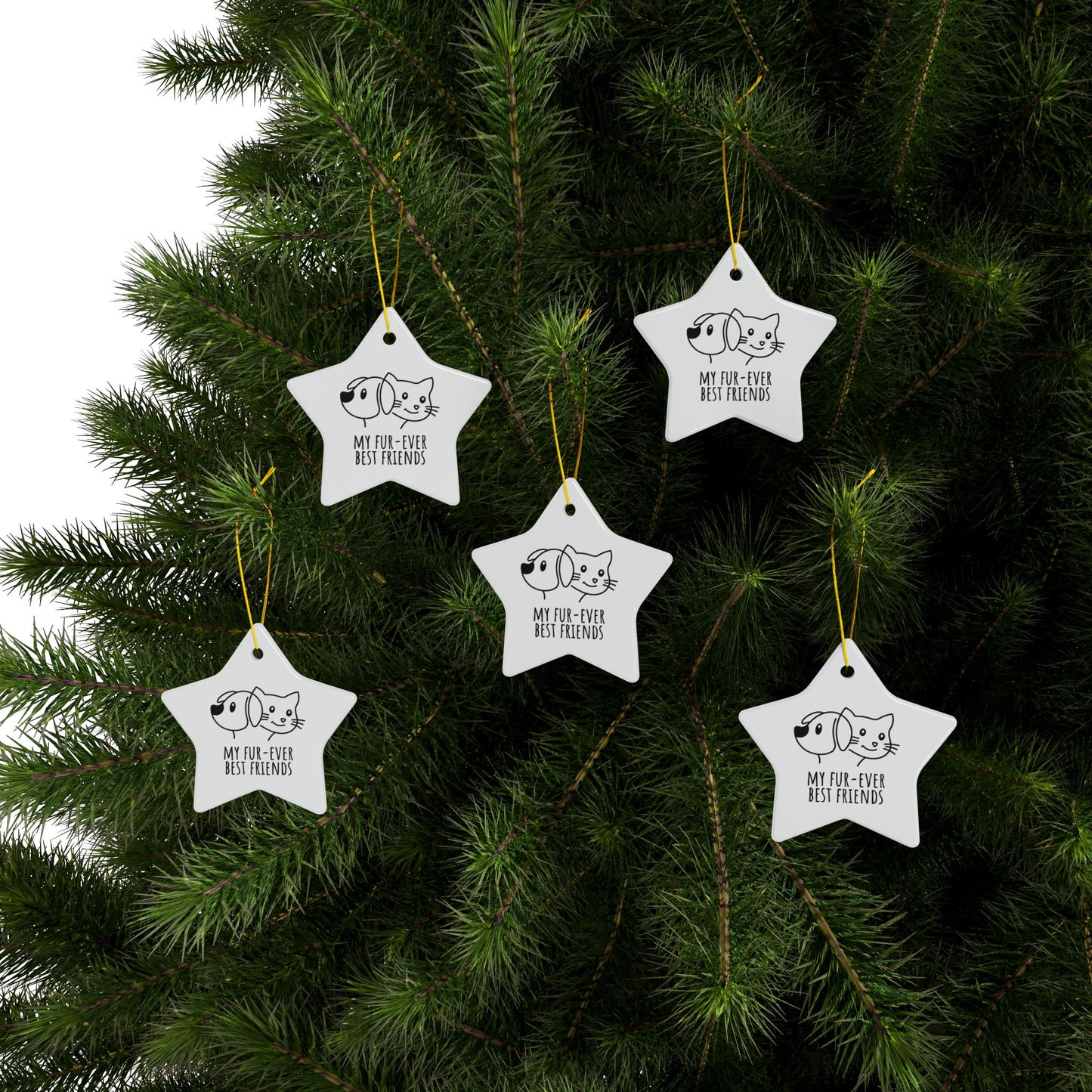 Star-shaped Christmas ornaments with cat illustrations on a tree