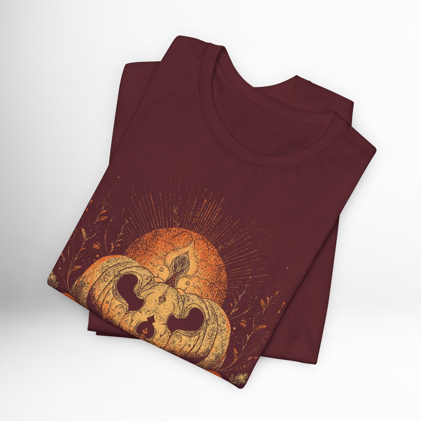 Maroon t-shirt with a pumpkin and moon design on a white background