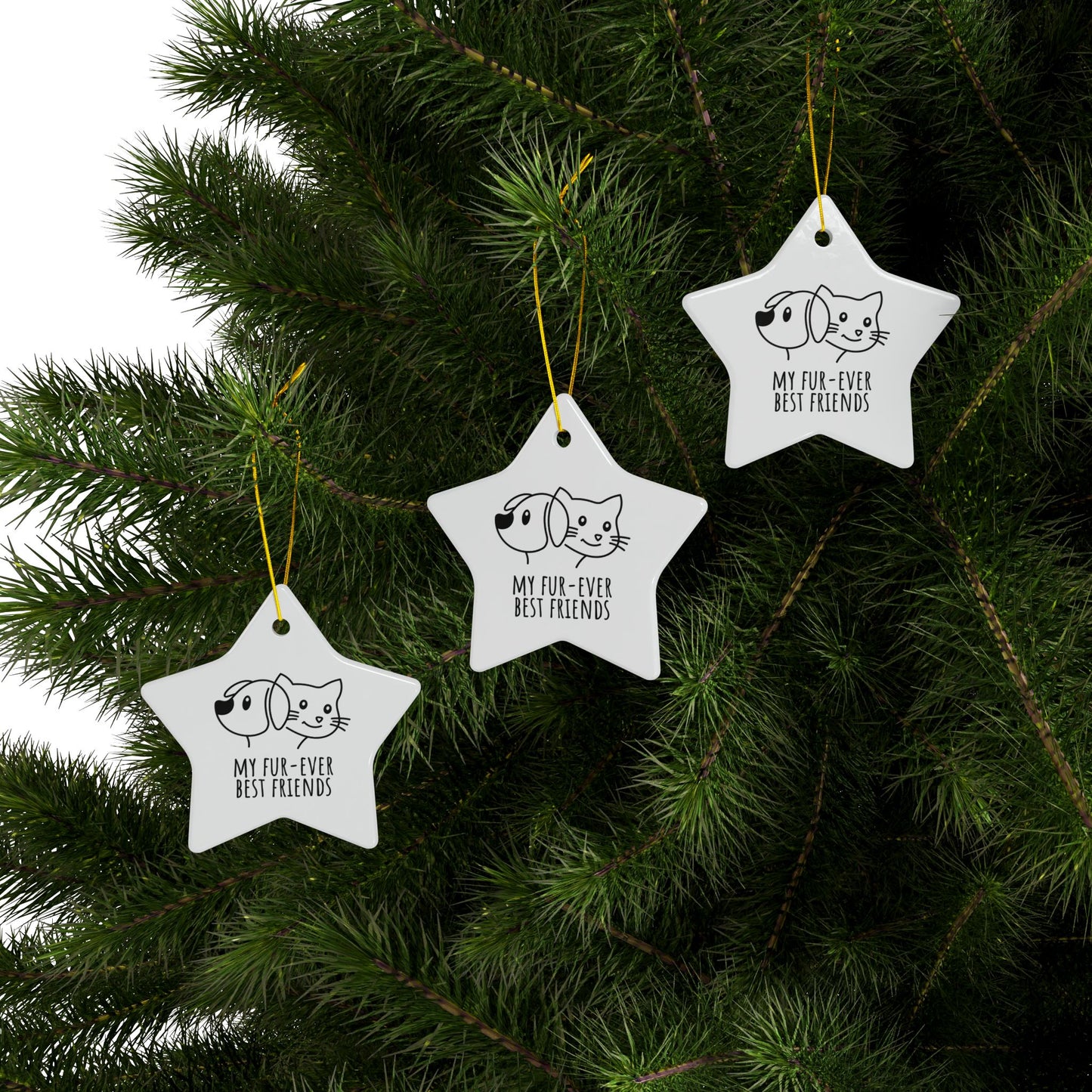 Star-shaped Christmas ornaments with dog and cat illustrations on a tree.