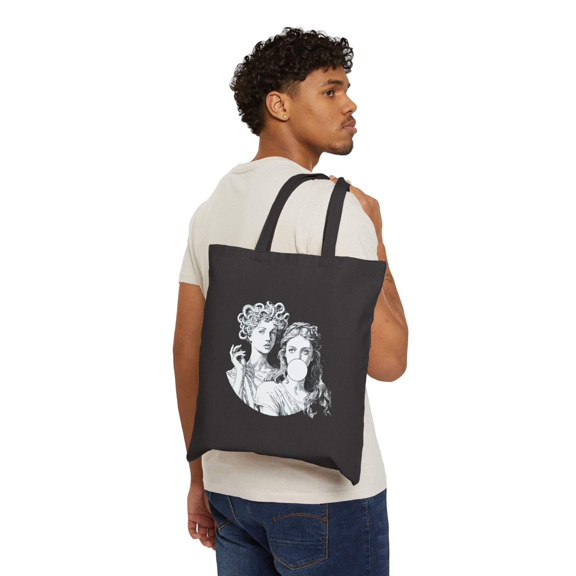 Man carrying a black tote bag with a graphic design on a white background