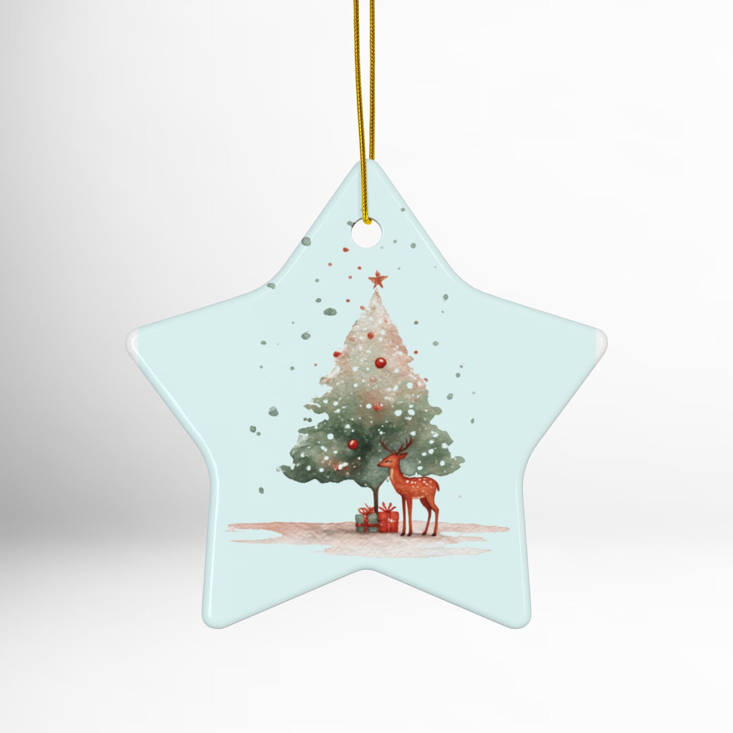 Star-shaped Christmas ornament with a deer and tree design on a light blue background.