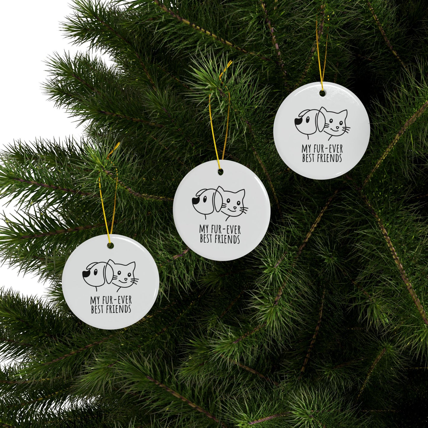 Three circular ornaments with dog and cat illustrations hanging on a Christmas tree.
