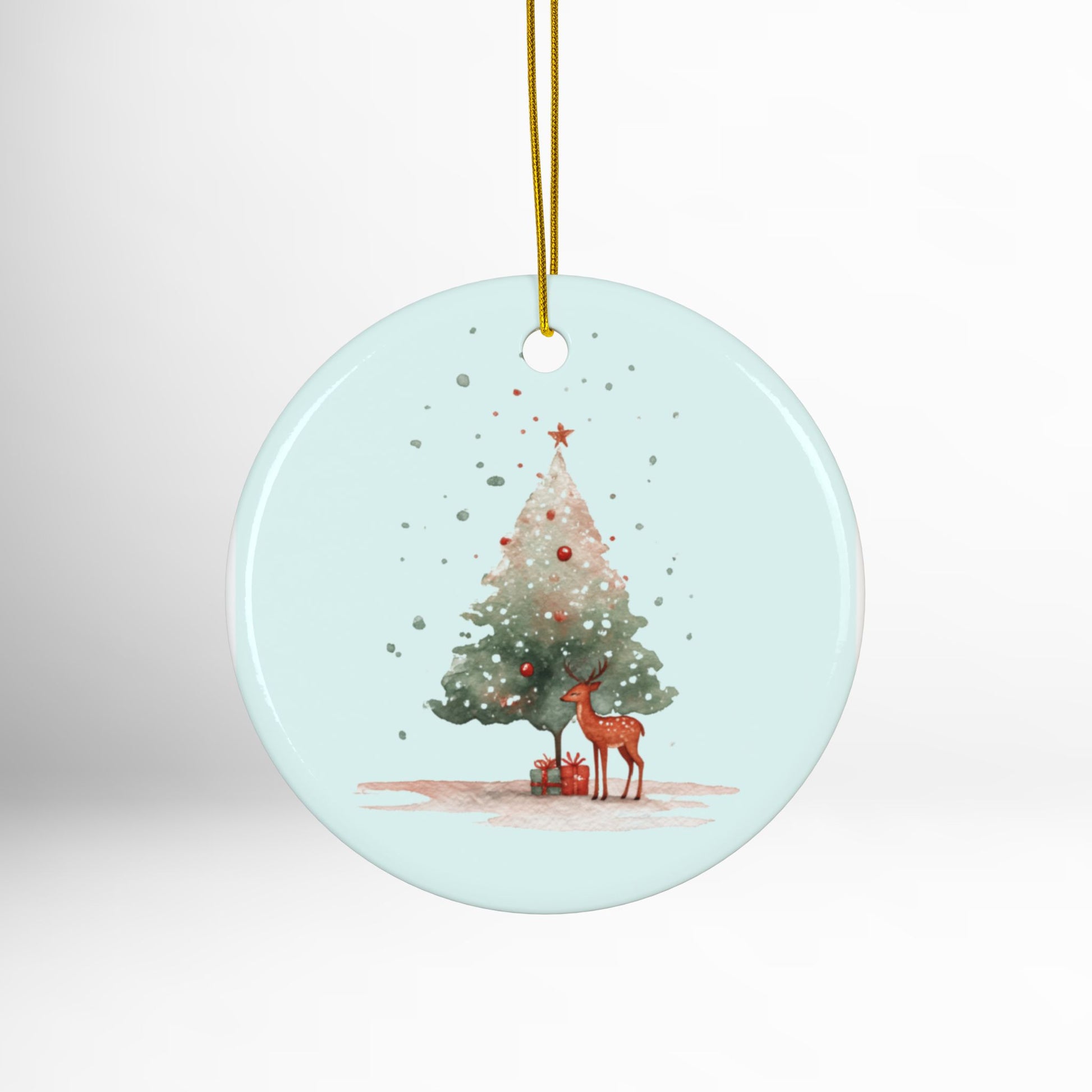 Round Christmas ornament with a deer and tree design on a light blue background