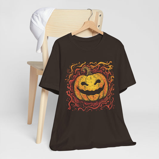 Black t-shirt with a Halloween pumpkin design on a wooden chair against a white background