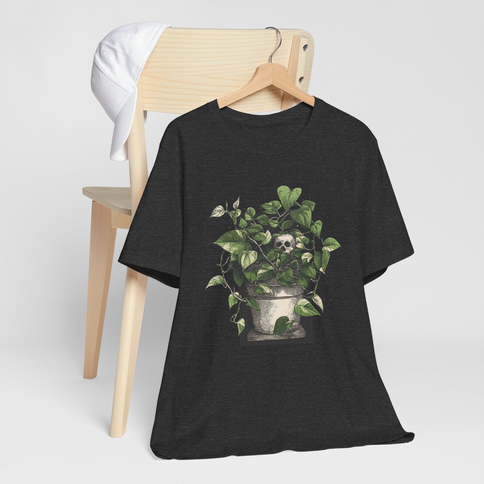 Black t-shirt with a plant and skull design on a white background