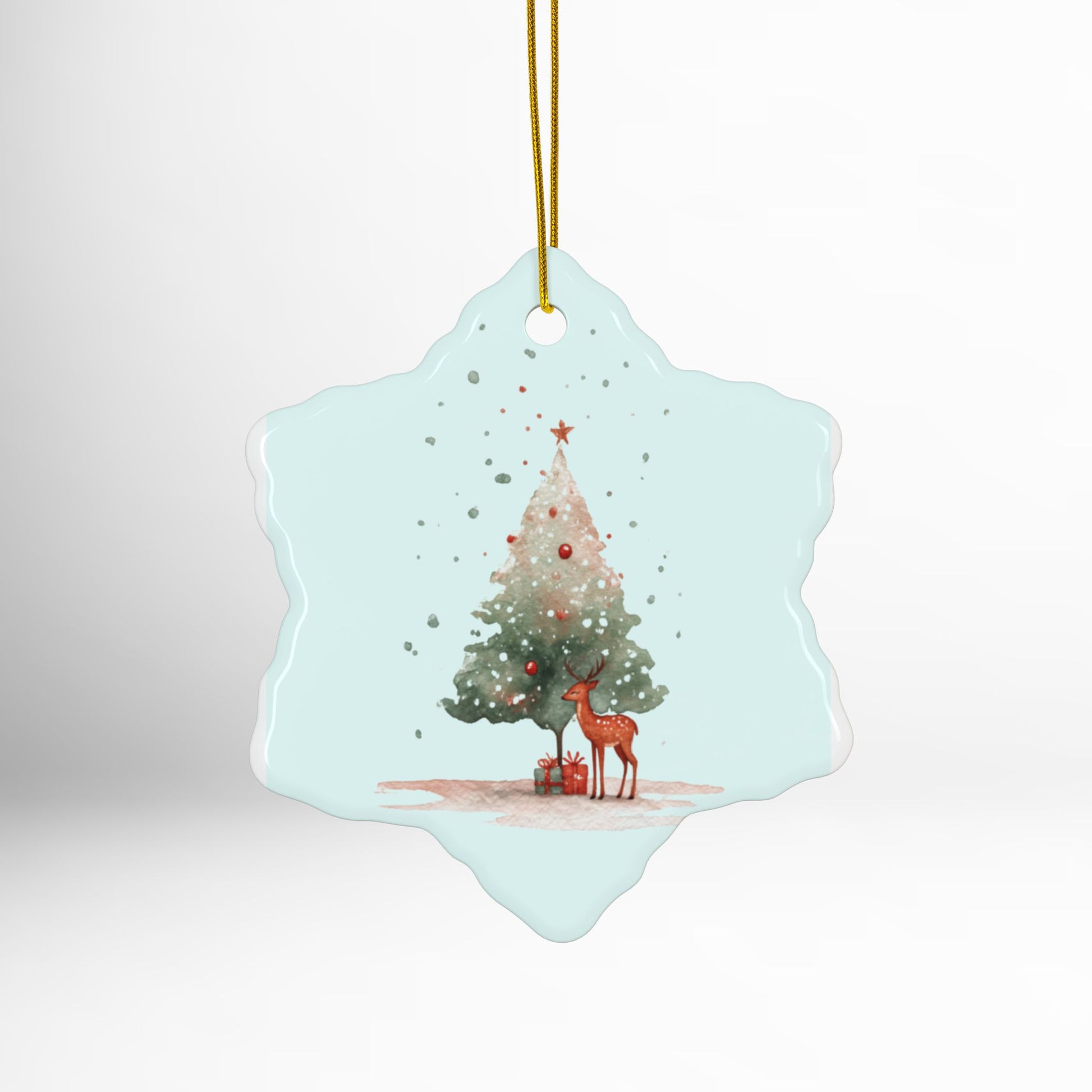 Decorative Christmas ornament with a deer and tree design on a light blue background