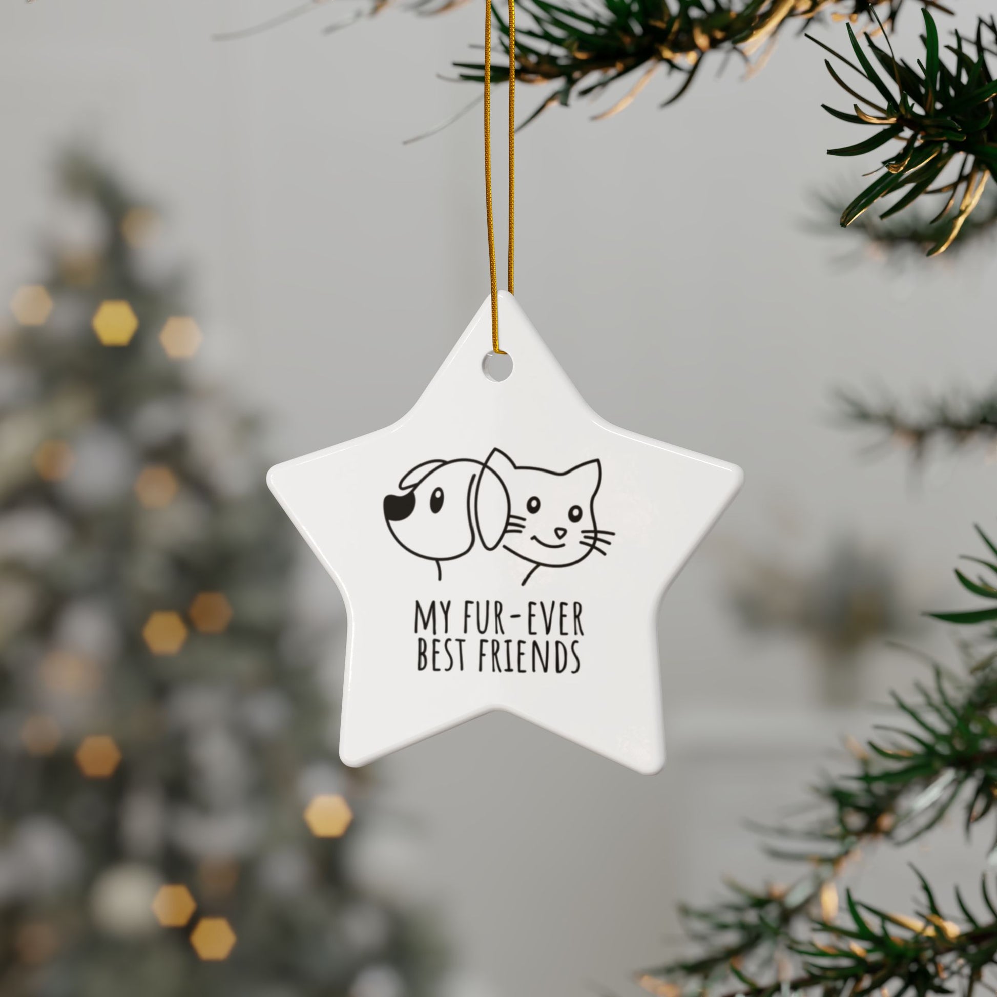 Star-shaped ornament with dog and cat illustration and text 'My fur-ever best friends' hanging on a tree.