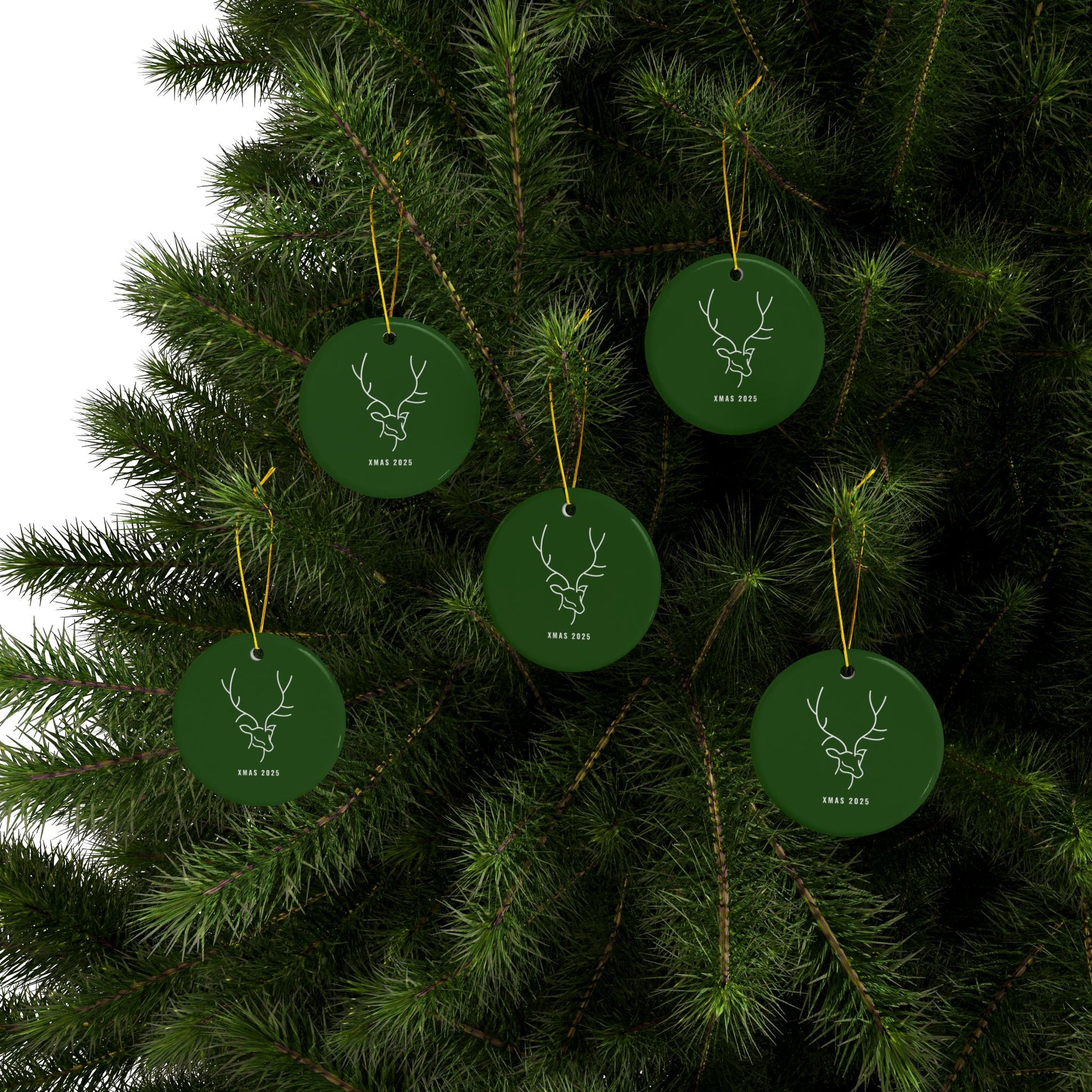 Green Christmas ornaments with deer designs on a tree