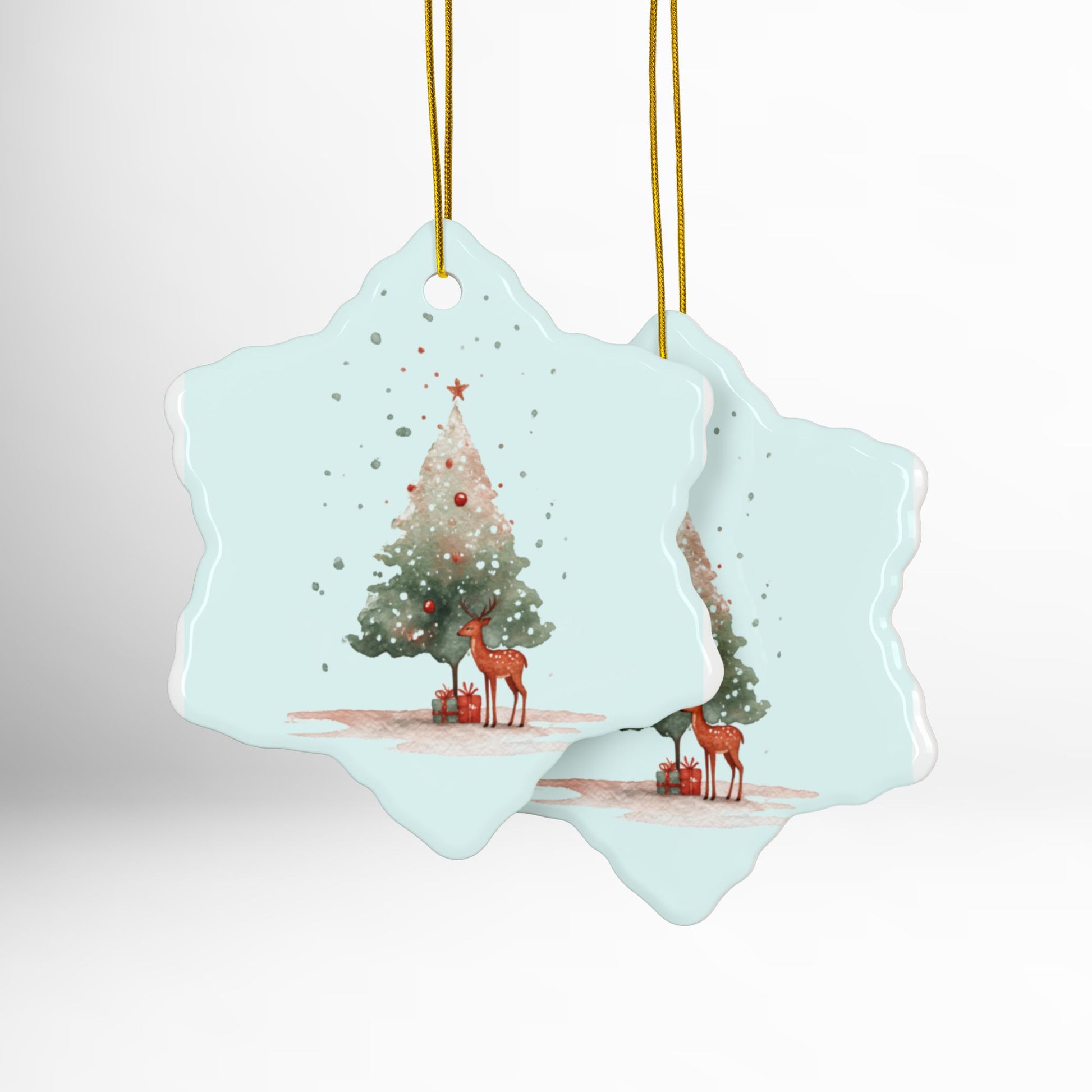 Decorative Christmas ornament with a Christmas tree and reindeer design on a light blue background.