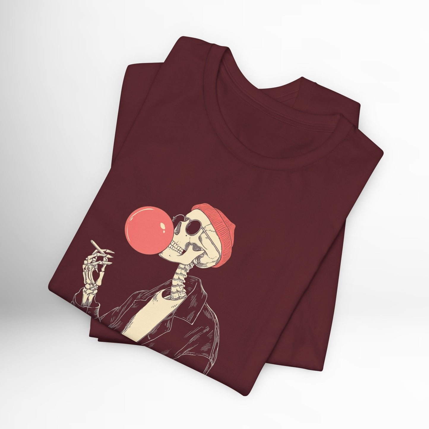 Maroon t-shirt with skeleton design blowing a bubble gum bubble on a white background