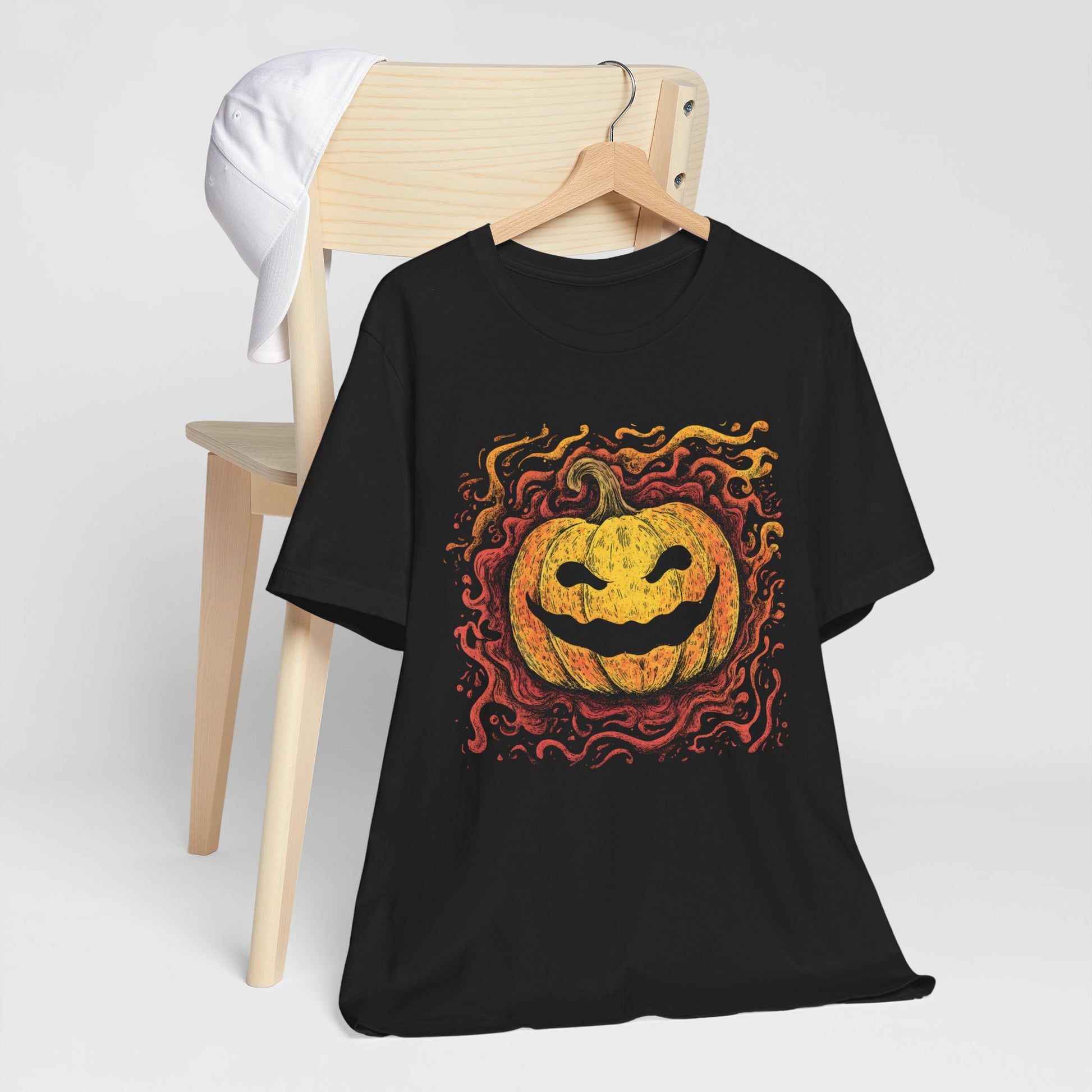 Black t-shirt with a Halloween pumpkin design on a white background