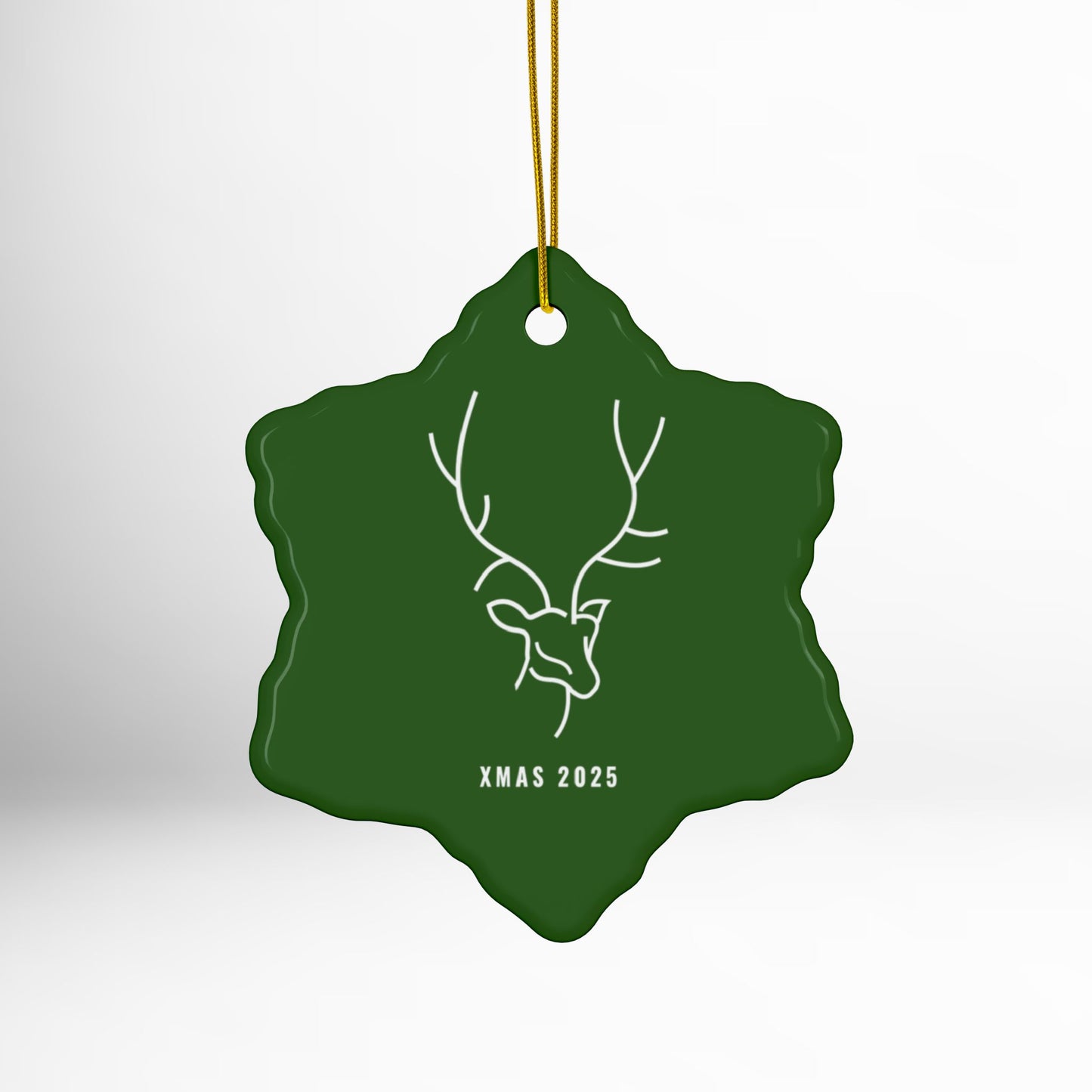 Green Christmas ornament with deer design and 'XMAS 2025' text on a white background