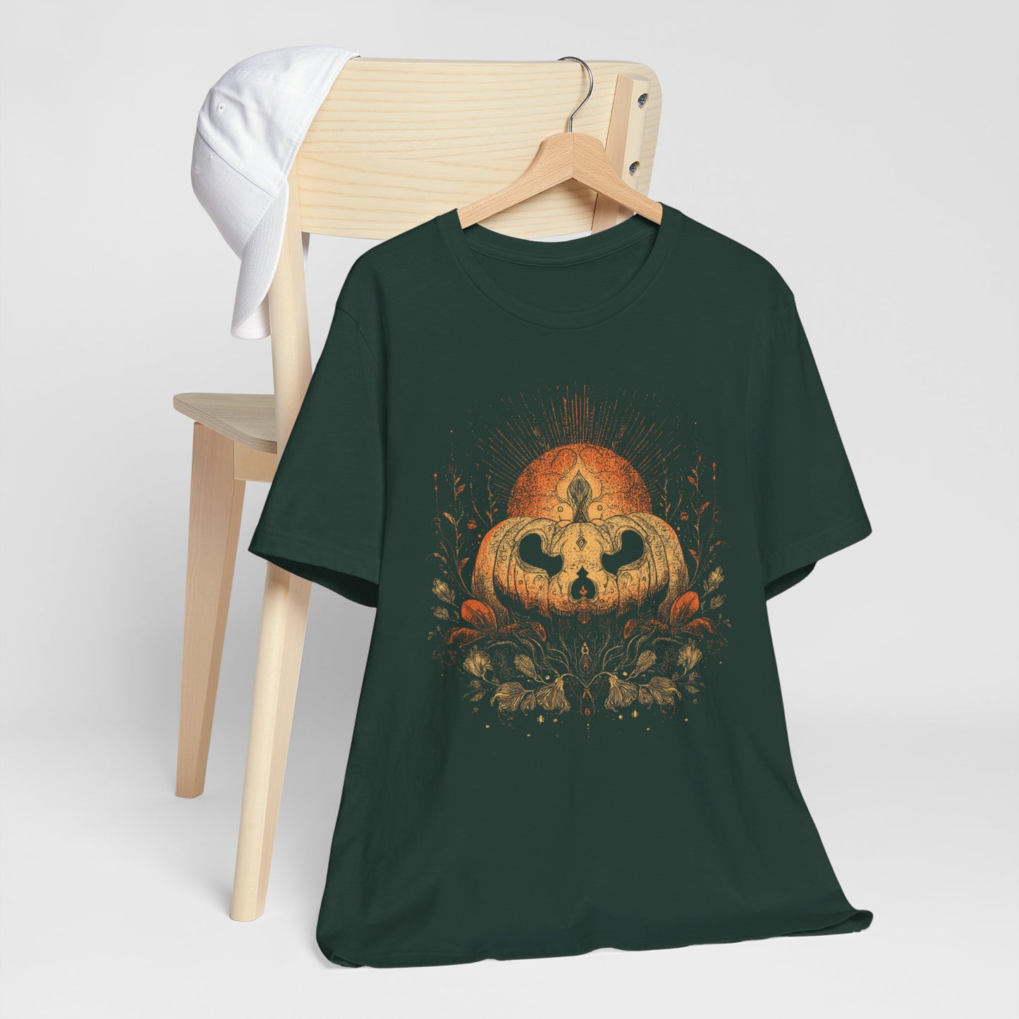 Dark green t-shirt with a pumpkin skull design on a white background