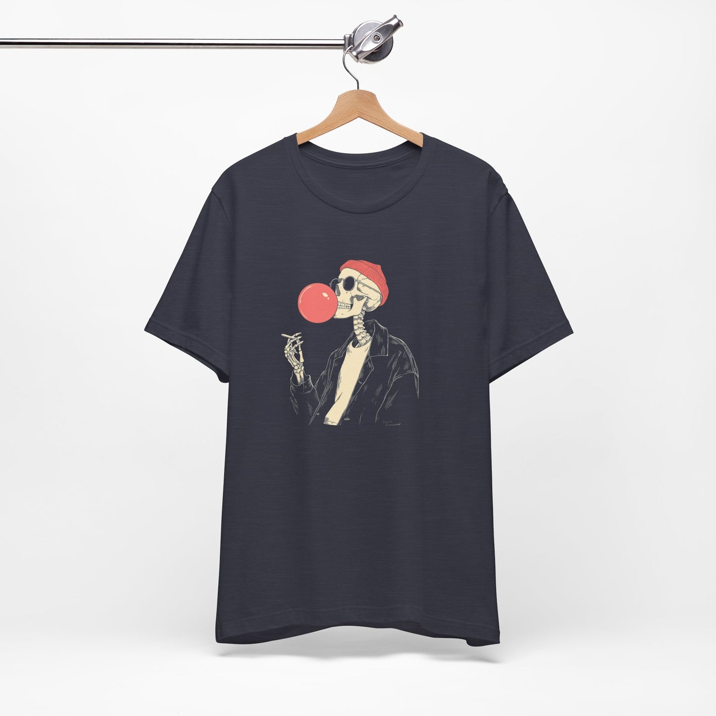 Black t-shirt with a skeleton wearing a Santa hat and blowing a red bubble gum bubble, hanging on a wooden hanger against a white background.